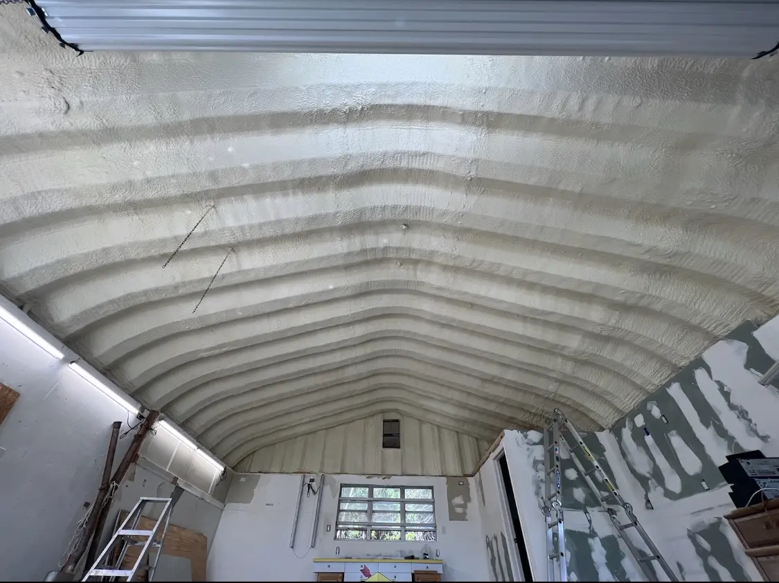 Spray polyurethane foam applied to the underside of a metal roof deck in Bridge City